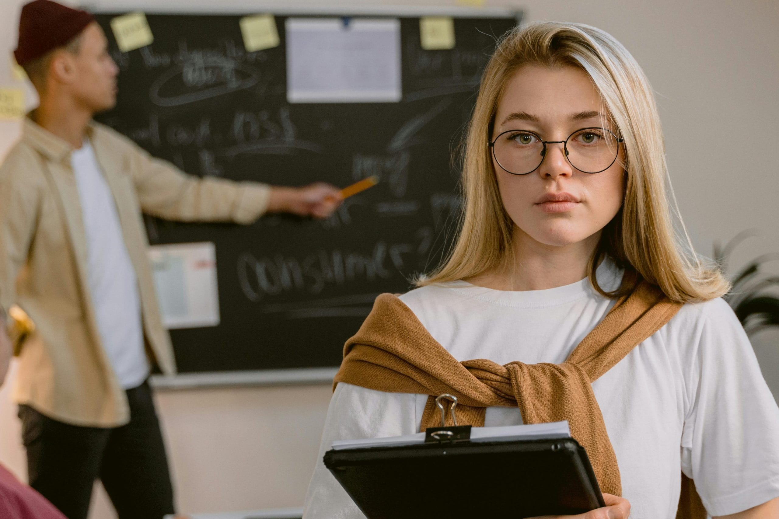 Business team engaged in project planning with blackboard and tablet in modern office.